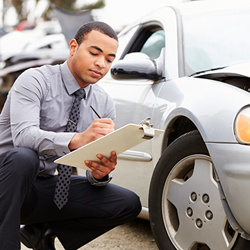 man checking the chart next to car